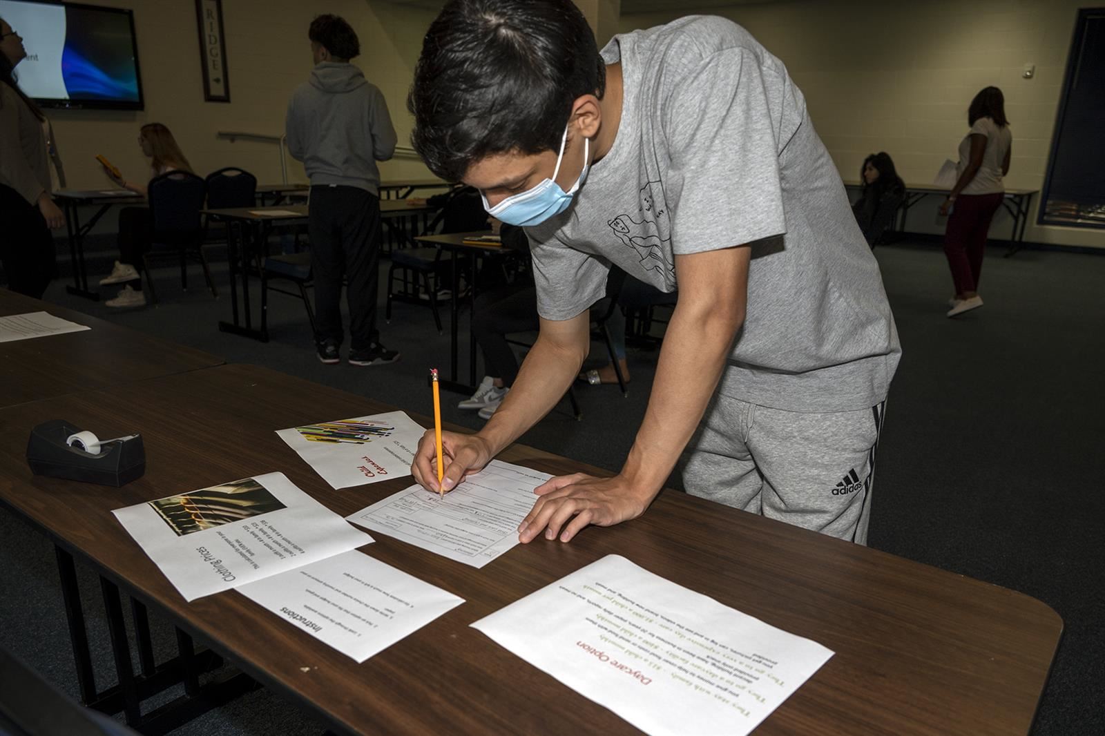 Cypress Ridge senior Steven Long works on his budget during a Budget Assessment lesson for his MMA class.